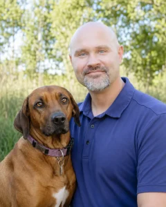 John Seal, an Idaho Elite K-9 Boarding Suites customer, with his dog
